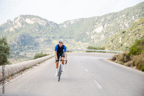Cyclist climbing a mountain pass on a road bike in Majorca
