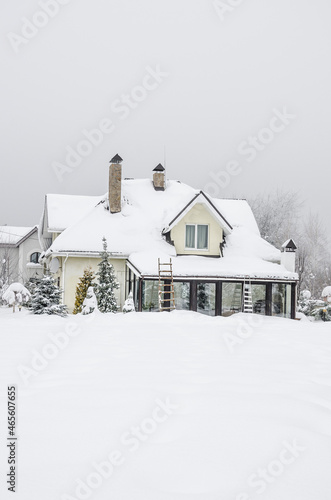 a private house and its garden under snow in winter © berna_namoglu