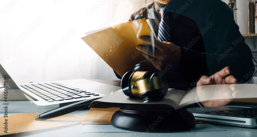Business and lawyers discussing contract papers with brass scale on desk in office. Law, legal services, advice, justice and law concept picture with film grain effect Business and lawyers discussing contract papers with brass scale on desk in office. Law, legal services, advice, justice and law concept picture with film grain effect