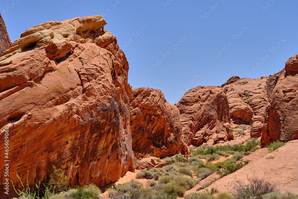 Rocks and cliffs of Red Aztec Sandstone line the Nevada desert