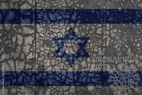 flag of israel on a old metal rusty cracked wall with text coronavirus, covid, and virus picture.