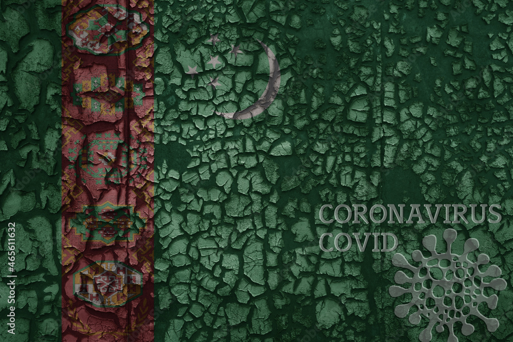 flag of turkmenistan on a old metal rusty cracked wall with text coronavirus, covid, and virus picture.