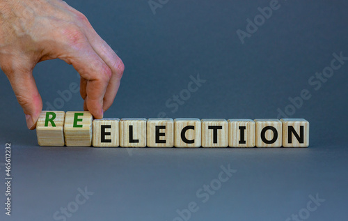 Election or reelection symbol. Wooden cubes with words 'Election reelection'. Businessman hand. Beautiful grey background. Business, politic, election or reelection concept. Copy space. photo