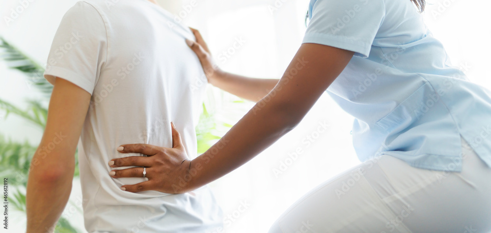 black rehabilitation woman physiotherapy at physio clinic with customer black rehabilitation woman physiotherapy at physio clinic with customer
