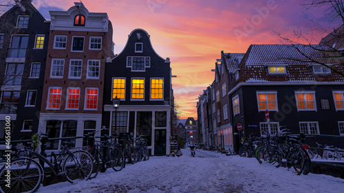Canvas Print City scenic from snowy Amsterdam in the Netherlands at sunset