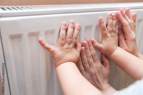 Baby hands measure battery temperature. Usually, the heating season in Ukraine starts either from October 15th and finishes on April 15th or it can start if the temperature is below 8C outside. photo