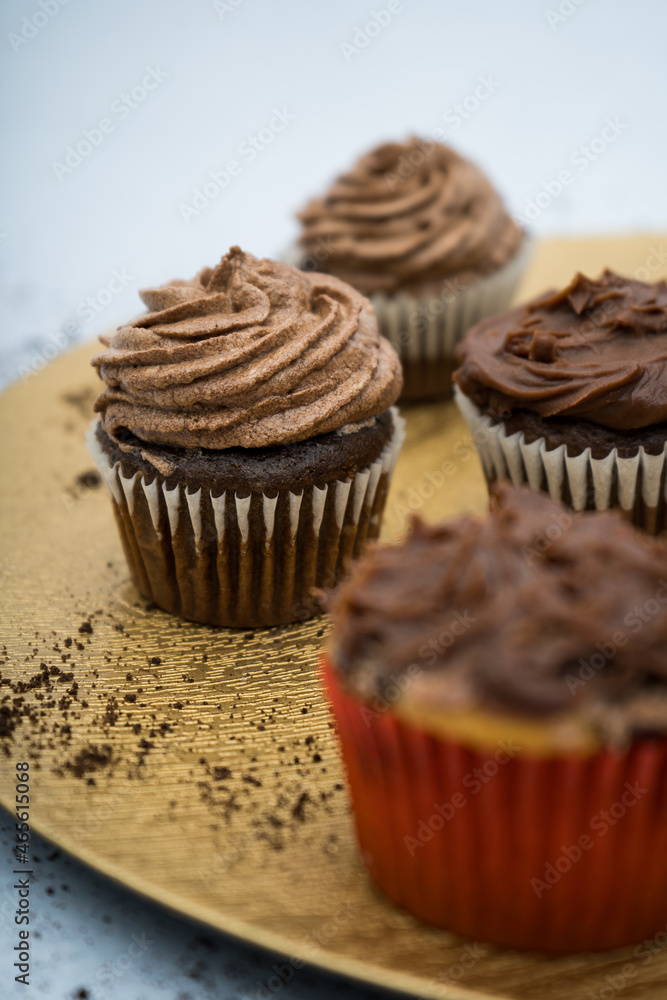 chocolate cupcakes on a golden plate with crumbs chocolate cupcakes on a golden plate with crumbs