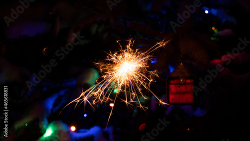 sparkler or bengal light burning on Christmas background