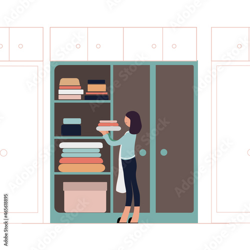 A woman puts her clothes away in a closet. Flat vector illustration