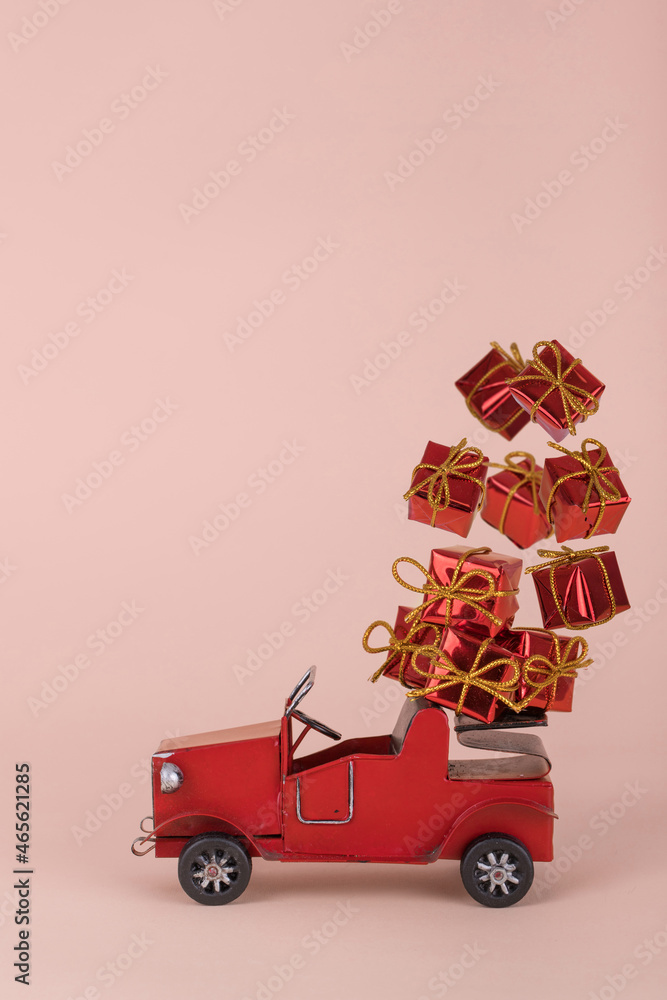 Creative idea with old red car carrying Christmas or New Year gifts that falling and flying in the air. Creative idea with old red car carrying Christmas or New Year gifts that falling and flying in the air.