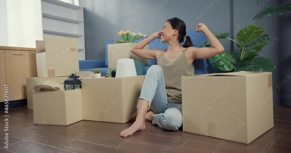Own House. Young attractive joyful Asian woman in casual sitting on floor enjoy celebrating real estate purchase and moving to new home in living room at house. Apartment ownership concept. Own House. Young attractive joyful Asian woman in casual sitting on floor enjoy celebrating real estate purchase and moving to new home in living room at house. Apartment ownership concept.