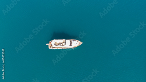 Minimalism. View from the height of a white yacht in the blue sea.