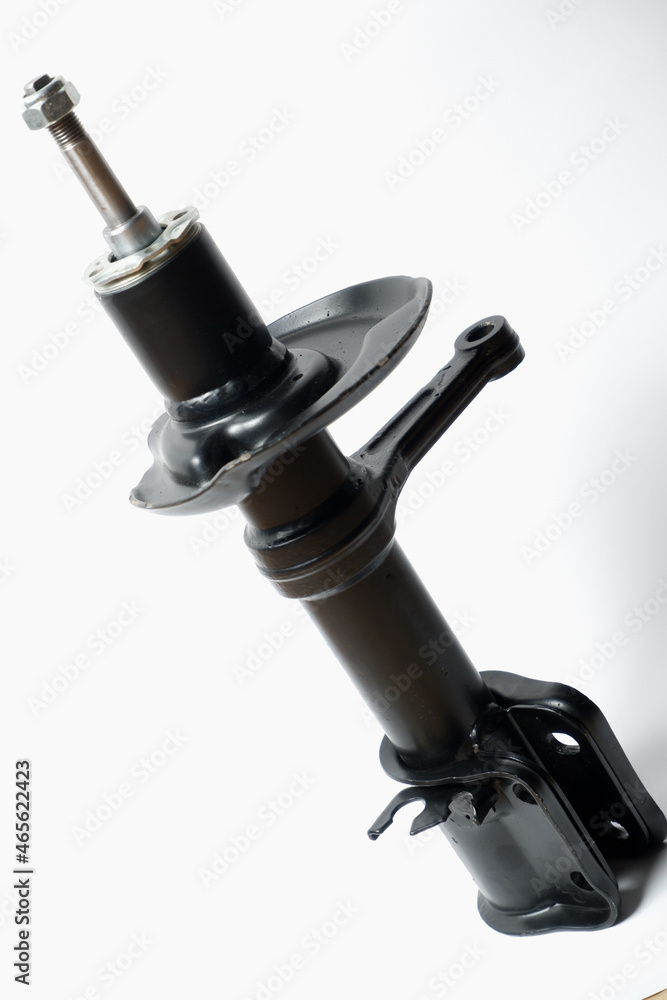 Car spare parts. Car front shock absorber. Contrasting photo on a white background. Front strut hydraulic shock absorber Car spare parts. Car front shock absorber. Contrasting photo on a white background. Front strut hydraulic shock absorber