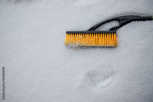 brush for cleaning car lies on the snow