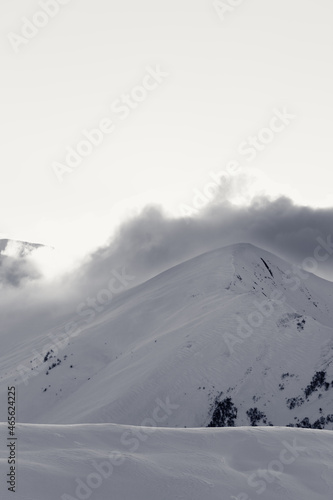 Black and white snowy off-piste slope in high mountains at winter evening © BSANI