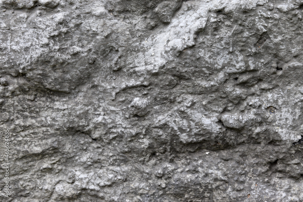 Stone background. The texture of a stone wall. Close-up. Light gray stone background. Stone background. The texture of a stone wall. Close-up. Light gray stone background.
