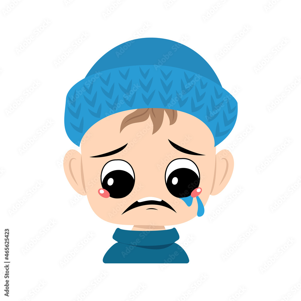 Boy with crying and tears emotion, sad face, depressive eyes in blue knitted hat. Cute kid with melancholy expression in autumnal or winter headdress. Head of adorable toddler Boy with crying and tears emotion, sad face, depressive eyes in blue knitted hat. Cute kid with melancholy expression in autumnal or winter headdress. Head of adorable toddler