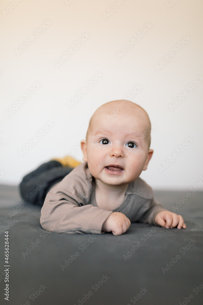 Cute 4 months old baby boy enjoying standing on his tummy. Cute 4 months old baby boy enjoying standing on his tummy.