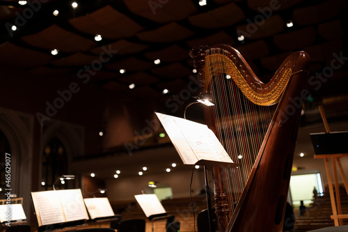 Fotografie, Tablou A harp during a pre concert setting with music stands with lights around it