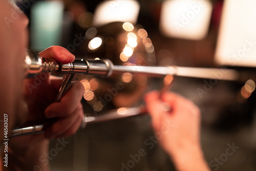 Photography A person playing a trombone in stage lights