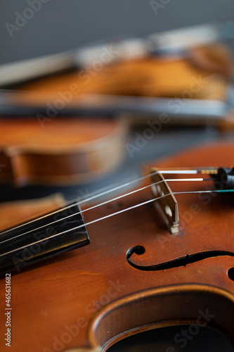 A shallow depth of field shot of a violin or a viola which is a string instrument that is common to a classical orchestra
