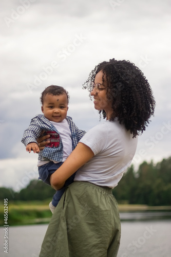 Young beautiful mother holds her baby in a hands
