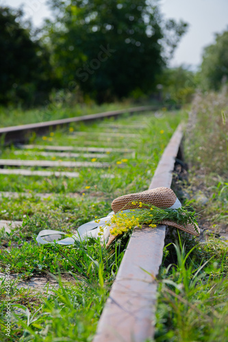 a beautiful hat lies on the rails alone