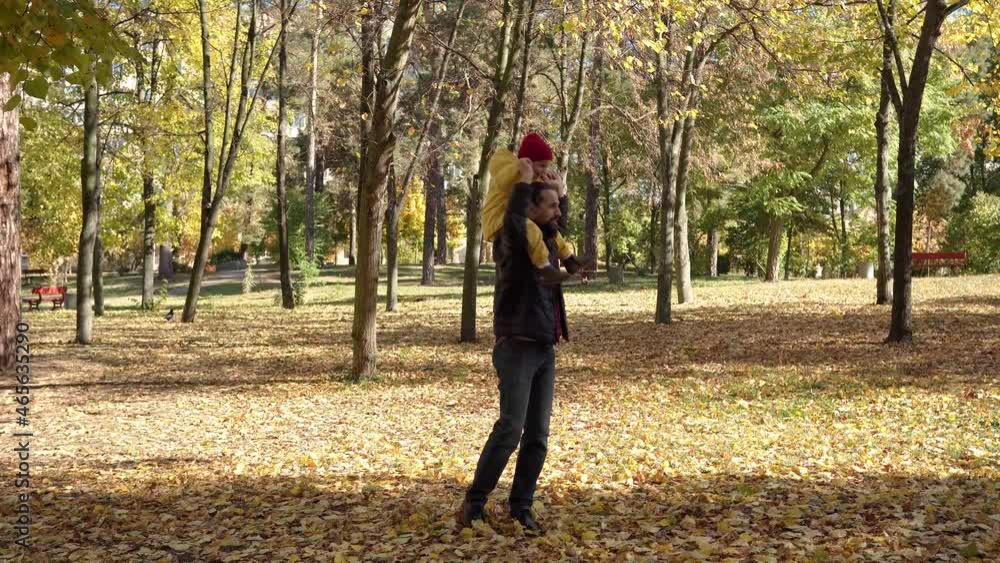 happy funny family daddy children kids have fun in park with dad enjoying autumn fall nature weather. father Kid sit on shoulders rolling spend time collect leaves together playing on forest landscape happy funny family daddy children kids have fun in park with dad enjoying autumn fall nature weather. father Kid sit on shoulders rolling spend time collect leaves together playing on forest landscape