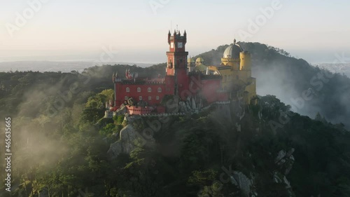 The colorful ancient castle with beautiful views over the Sintra region. Drone footage of The Palacio da Pena at the top of a steep hill. Europe, Portugal, Pena Palace. High quality 4k footage photo