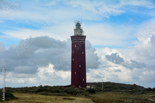 Westhoofd lighthouse in Ouddorp in the Netherlands, in a green landscape and sky photo