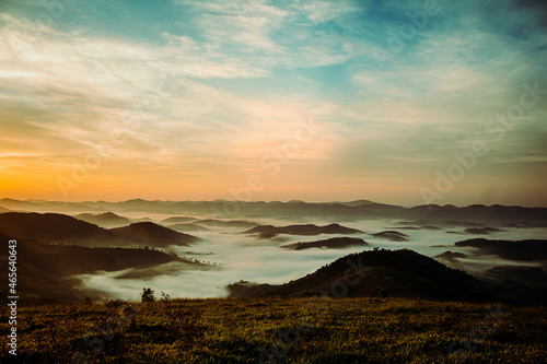 blue and yellow sky background with white clouds