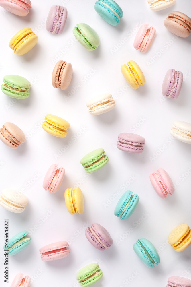 Colorful French macaron cookies on a solid plain white background, Spring pastel color cookies flat lay, Contemporary food art Colorful French macaron cookies on a solid plain white background, Spring pastel color cookies flat lay, Contemporary food art