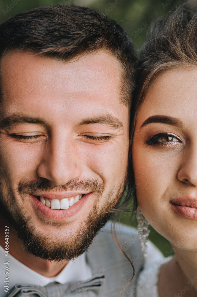 Wedding portrait, photograph of half of the faces of beautiful, cheerful and smiling newlyweds. Wedding portrait, photograph of half of the faces of beautiful, cheerful and smiling newlyweds.