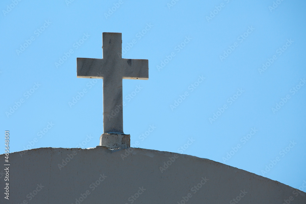 marble cross on a dome of a christian church  against blue sky