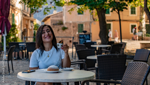 Italian woman drinking coffee in cafe in Spain