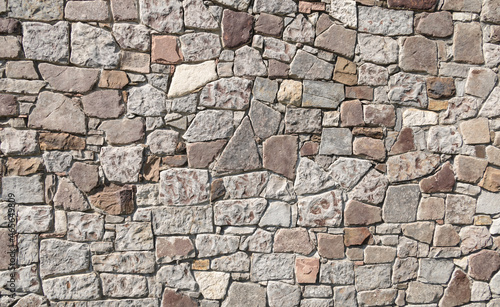 Multi-colored stone wall  artistic grey material background. Abstract detail seamless wall. Exterior ancient loft style texture concept. Abstract material background  rough and weathered surface.