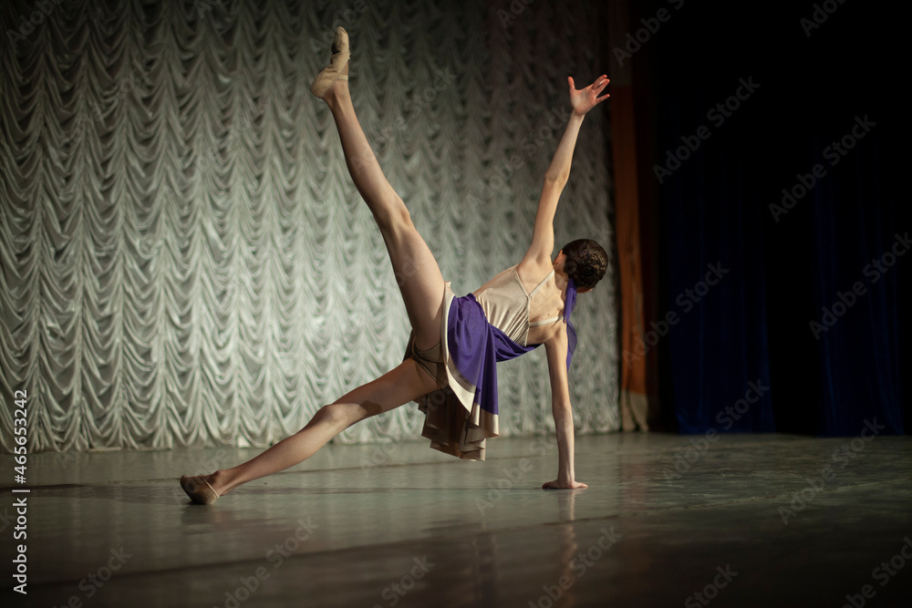 Dancer on stage. A girl in a purple dress.