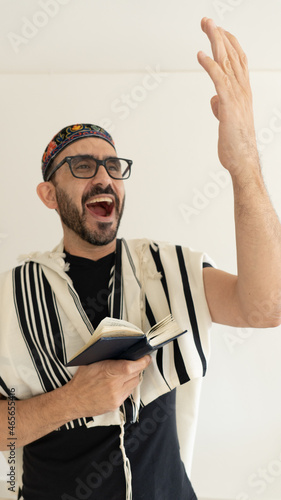 Jewish Bearded Man Praying with a big kip on his head. the man in showing he's hand during singing