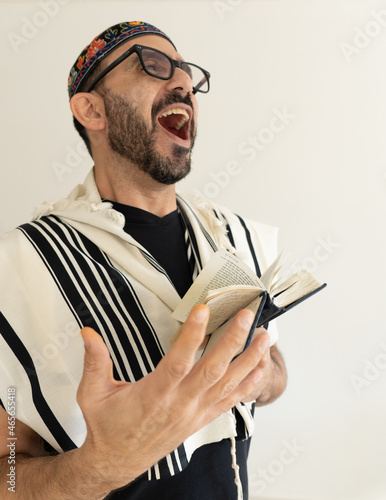 Jewish Bearded Man Praying with a big kip on his head. the man in showing he's hand during singing