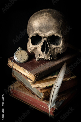 Human skull on antique books. Black background with space for text