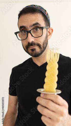 Jewish Bearded Man holding Havdala Candle on his hand