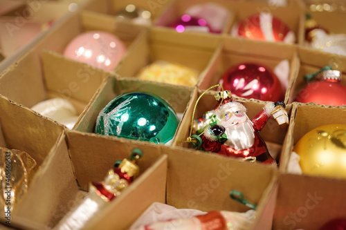 Variety of colorful Christmas baubles in a boxes. Trimming the Christmas tree.