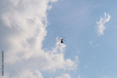 Airplane flying in the sky, On the azure sky, a helicopter flies.