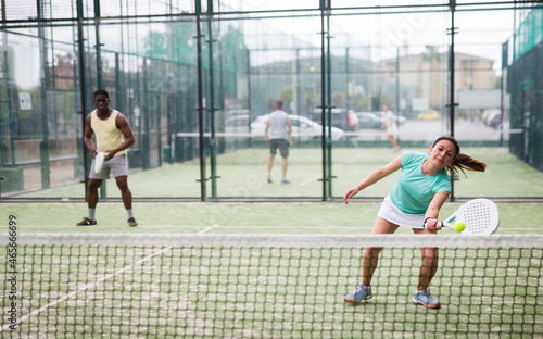 Two sports couples playing padel on the tennis court