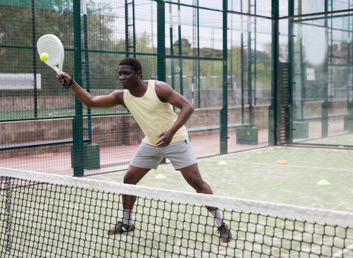 African american man playing paddle tennis outdoor © JackF