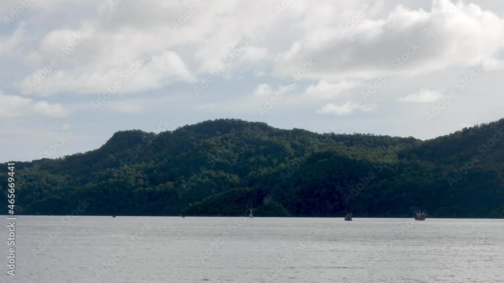 View of the seaside overlooking the sea and mountains with gentle waves on a holiday in good weather, Satun Province, Thailand. View of the seaside overlooking the sea and mountains with gentle waves on a holiday in good weather, Satun Province, Thailand.