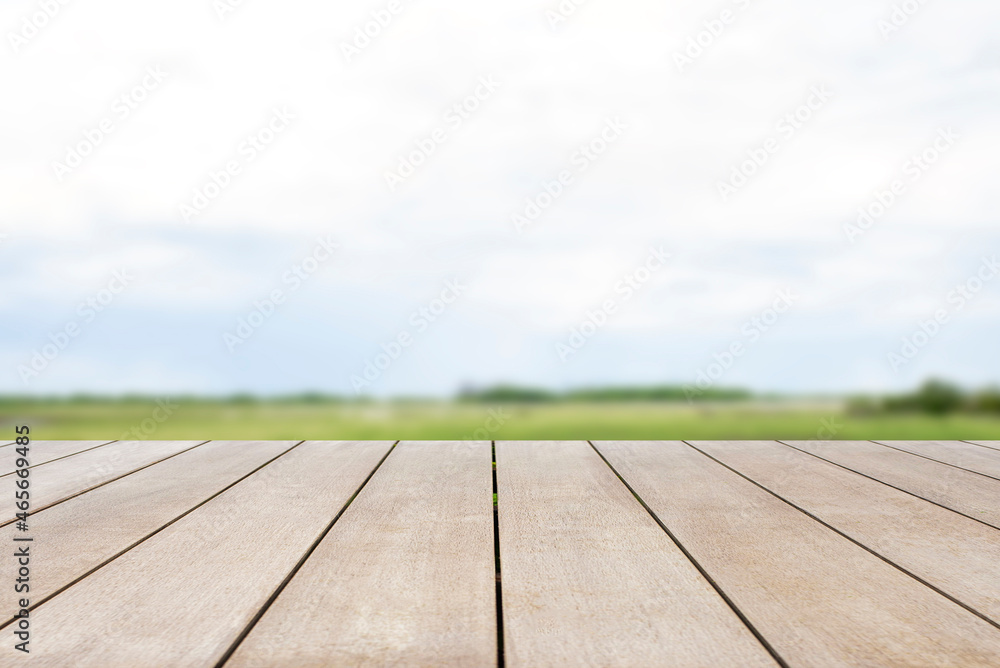 Empty old wooden table in front of blurred beautiful grassland and mountain with clear sky background of nature. Can be used for display or montage for show your products.