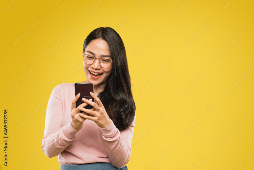woman in glasses smiling while using a mobile phone woman in glasses smiling while using a mobile phone