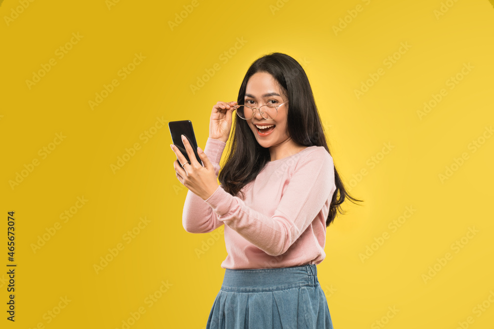 beautiful woman laughing looking at the screen of a smartphone beautiful woman laughing looking at the screen of a smartphone