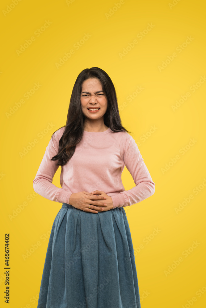 Obraz premium asian woman with hands on stomach with pain expression